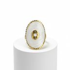 Gold Oval Statement Ring  on a white pedestal against a white background