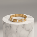 Gold Pearl Accent Bracelet on a marble surface