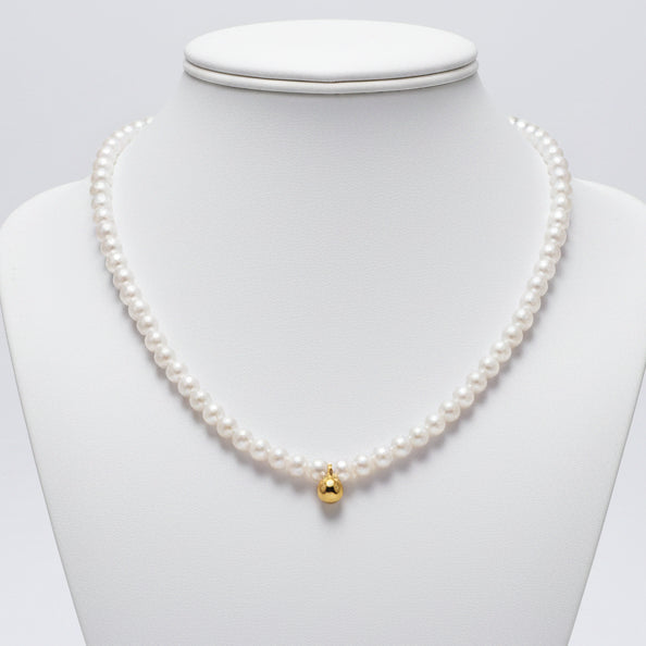 Gold Pearl Bead Necklace plain background