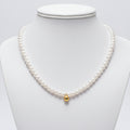 Gold Pearl Bead Necklace plain background
