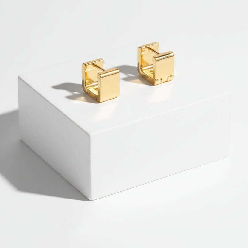Gold Rectangular Huggie Hoop Earrings on a white background