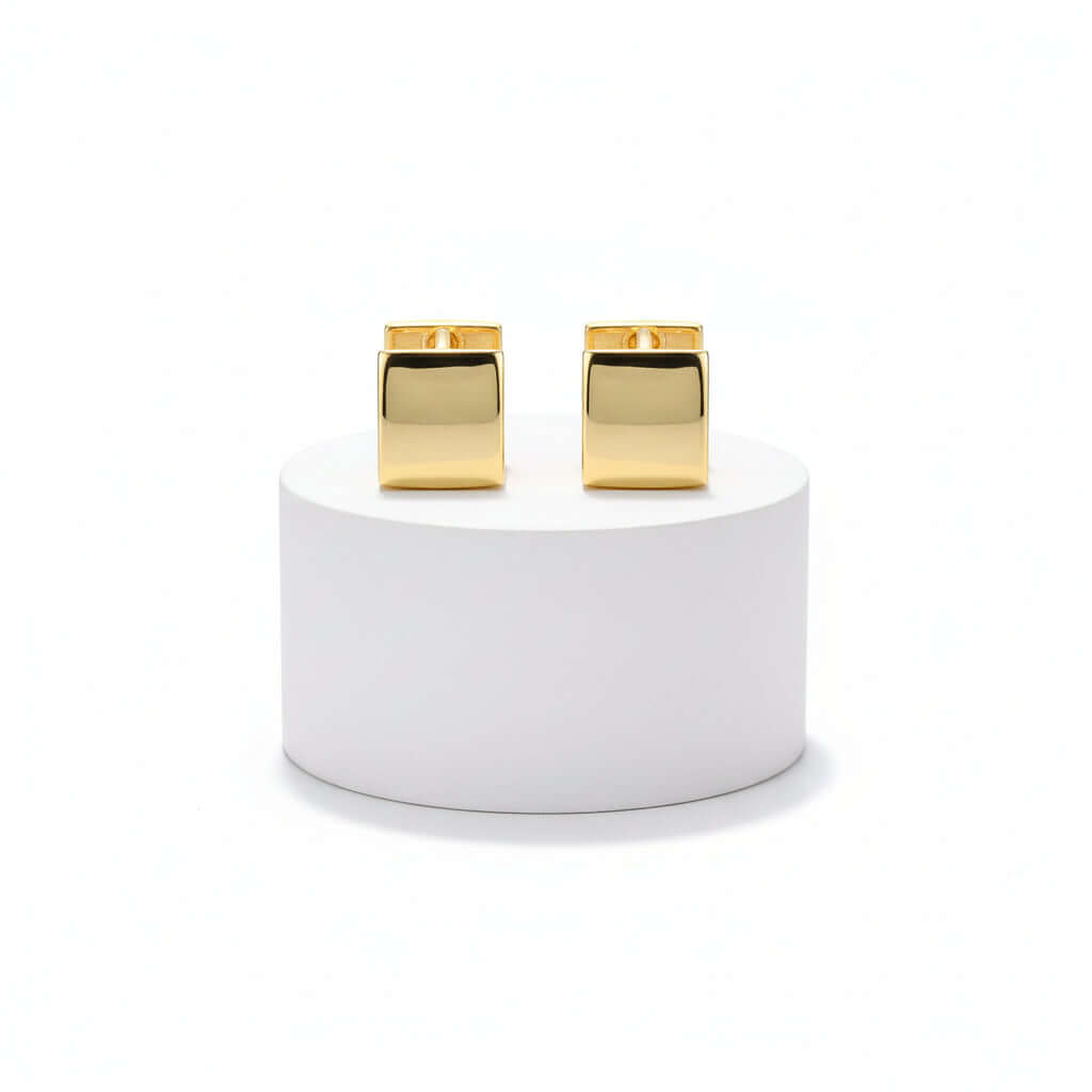 Pair of Gold Rectangular Huggie Hoop Earrings on a white background