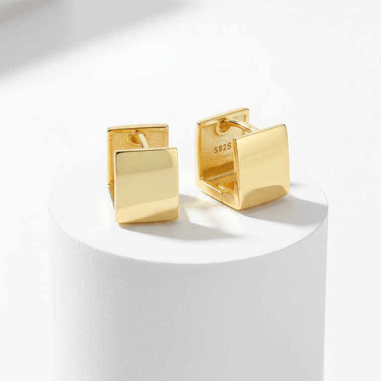 Gold Rectangular Huggie Hoop Earrings  on white pedestal