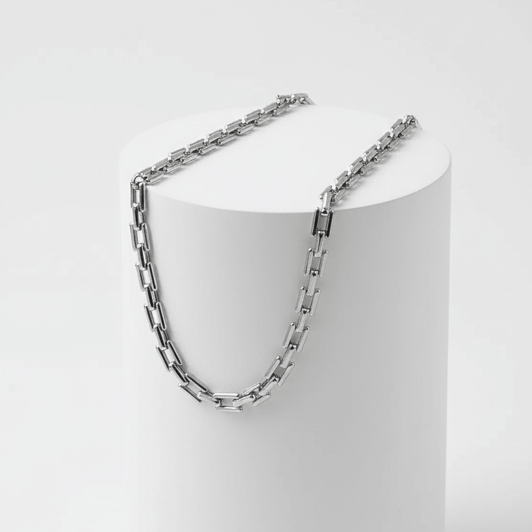 Silver Rectangular Link Chain Necklace on white pedestal 