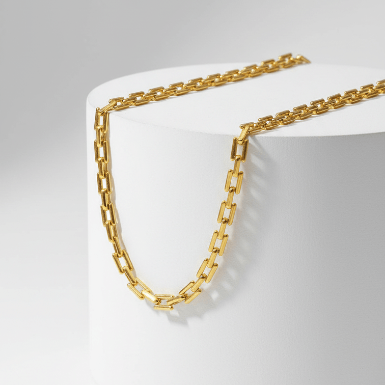 Gold Rectangular Link Chain Necklace on white pedestal 
