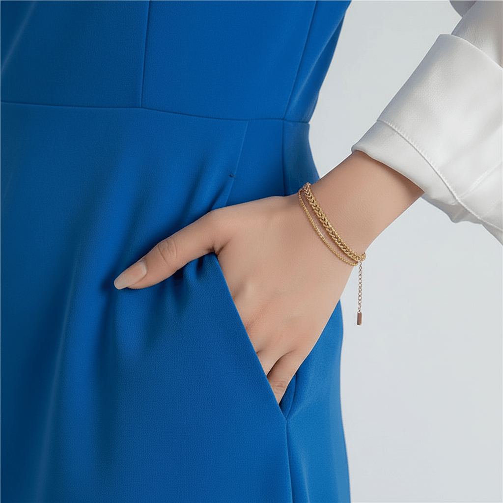 Gold Rope Chain Adjustable Bracelet on a wrist with a white shirt and black pants against a light gray background