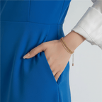 Gold Rope Chain Adjustable Bracelet on a wrist with a white shirt and black pants against a light gray background