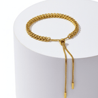 Gold Rope Chain Adjustable Bracelet on a white cylindrical stand with a white background
