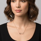 Woman wearing a Gold Safety Pin Pendant Necklace against a neutral background