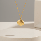 Gold Scallop Shell Pendant Necklace with a shell pendant on a neutral background