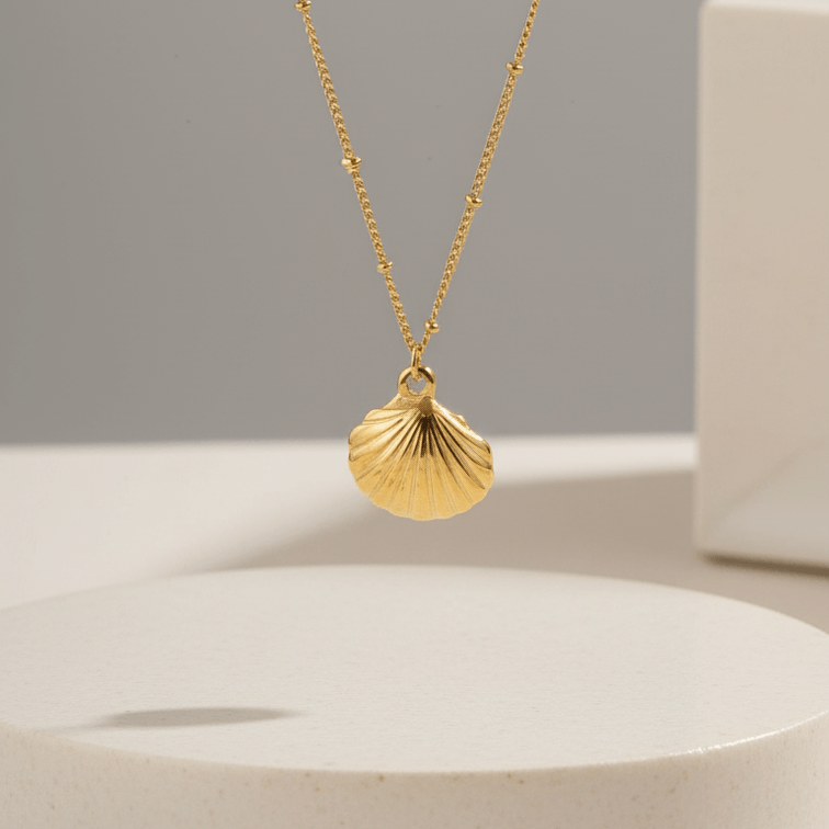 Gold Scallop Shell Pendant Necklace with a shell pendant on a neutral background
