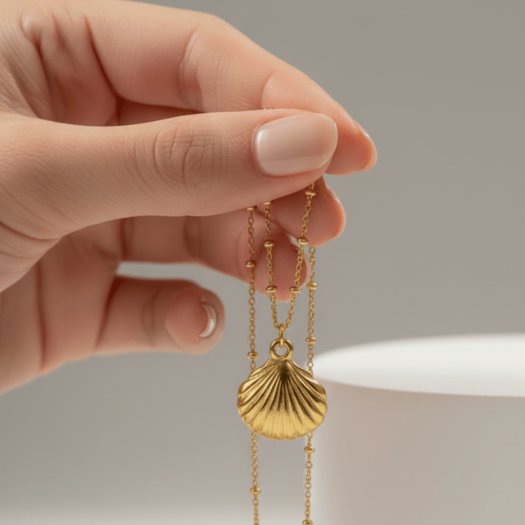 Gold Scallop Shell Pendant Necklace on hand
