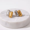 A pair of Gold & Silver Capsule Stud Earrings displayed on a clean white background with dimension 