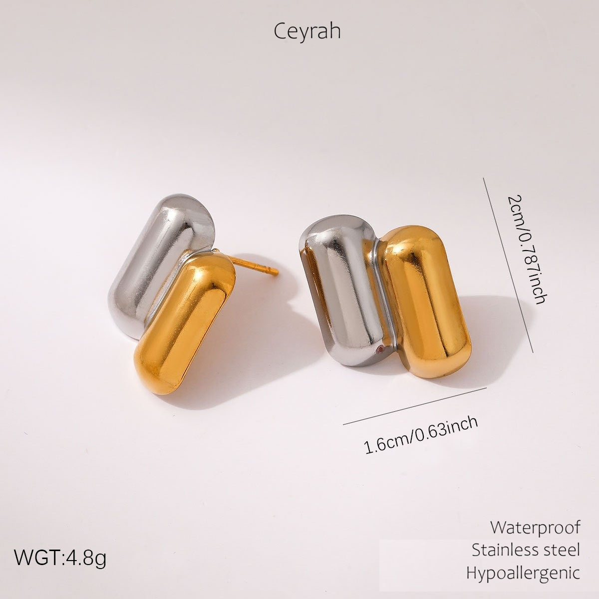 A pair of Gold & Silver Capsule Stud Earrings, shown on a light gray background with size and weight text overlays.
