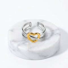 Gold & Silver Heart Adjustable Ring with a textured gold heart-shaped accent in the center, shown with printed dimensions and weight on a white background.