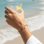 Gold Starfish Bangle Bracelet on women's hand
