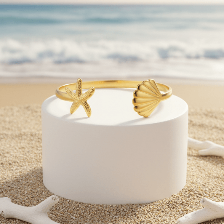 Gold bracelet on a white cylindrical stand with a beach background
