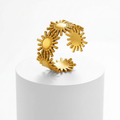 Gold Sunburst Adjustable Ring on white pedestal