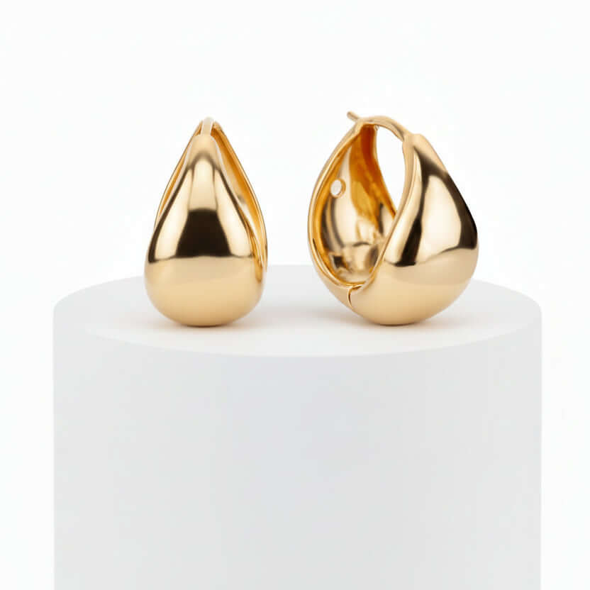 Gold Teardrop Mini Hoop Earrings on a white pedestal with a white background