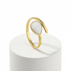 Gold Teardrop Wrap Ring featuring a smooth white teardrop center and an adjustable gold-tone frame.