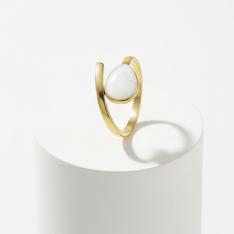Gold Teardrop Wrap Ring featuring a smooth white teardrop on a polished gold-tone band.