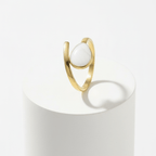 Gold Teardrop Wrap Ring featuring a smooth white teardrop on a polished gold-tone band.