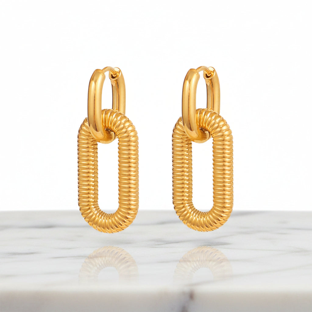 A pair of Gold Textured Oval Link Hoop Earrings shown on a plain white background.