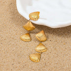 Gold Tiered Seashell Earrings on a sandy background