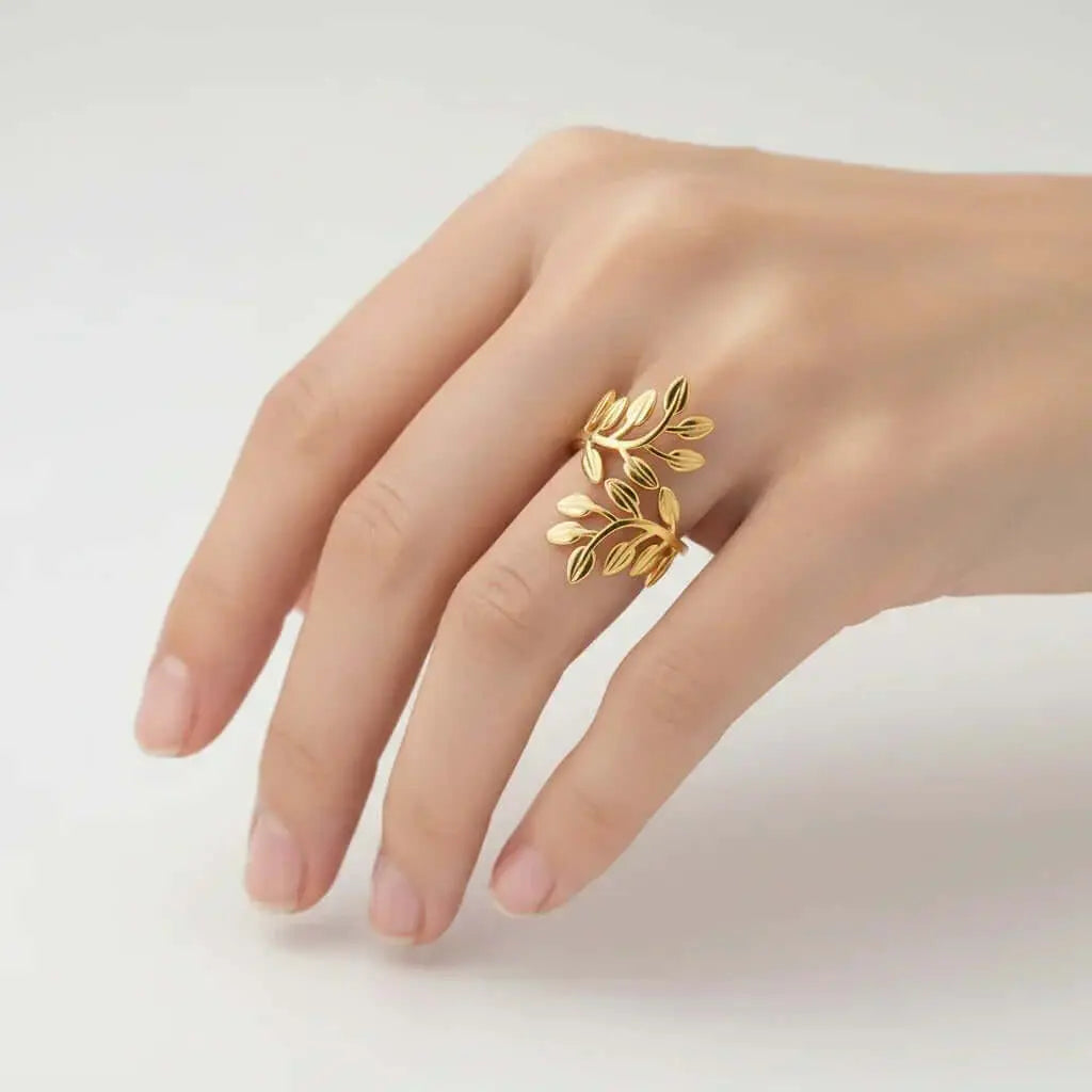 Gold leaf-shaped ring from Ceyrah on hand, minimalist jewelry design