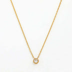 Ceyrah minimalist gold chain necklace with round crystal pendant on white background