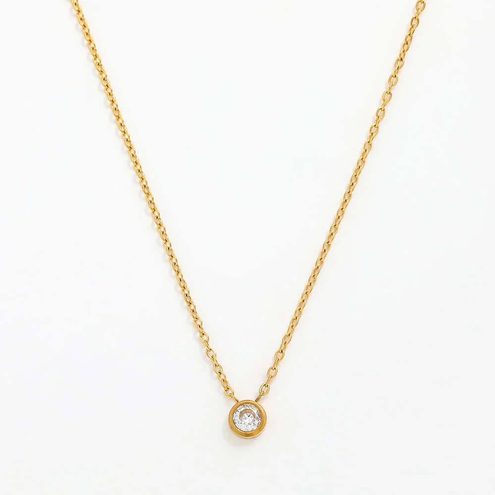 Ceyrah minimalist gold chain necklace with round crystal pendant on white background