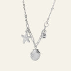 Ceyrah silver necklace with starfish, seashell, and letter charms on delicate chain