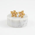 Gold Floral Stud Earrings with Cream Pearl on white background