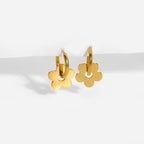 Ceyrah gold hoop earrings with flower-shaped charms on white background