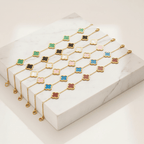 Ceyrah gold clover enamel bracelets in green, black, white, pink, blue, and red on display
