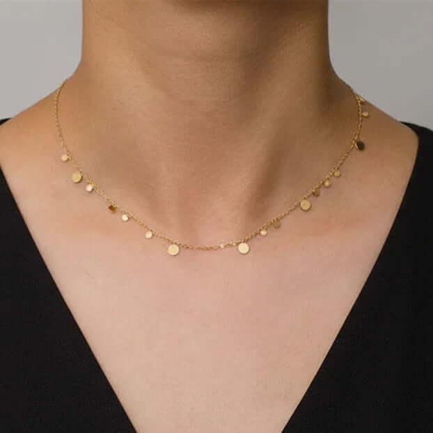 Ceyrah delicate gold disc necklace on woman's neck, minimalist jewelry style