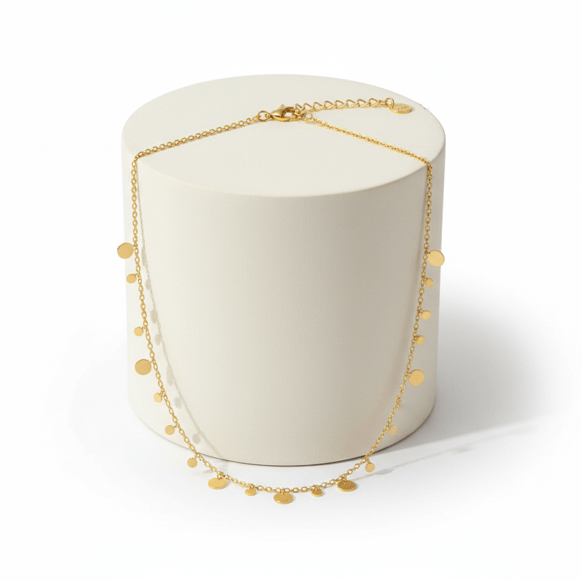 Ceyrah gold coin charm necklace on delicate chain, minimalist jewellery on pedestal 