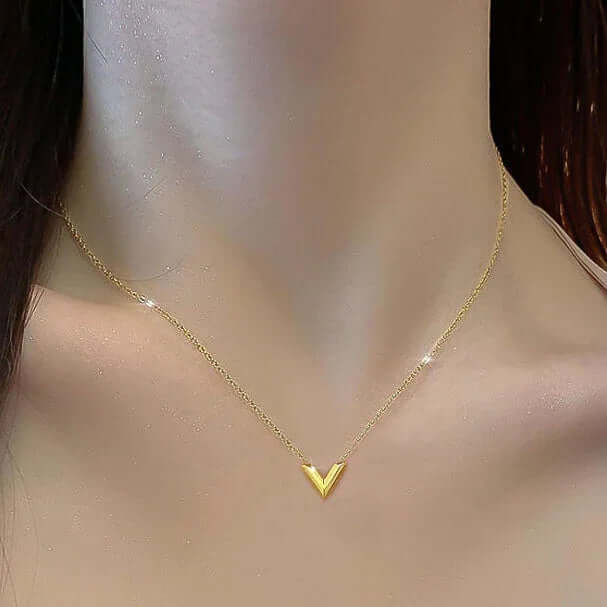 Gold V pendant necklace on model, minimalist jewelry by Ceyrah