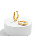 Pair of Twisted U Shaped Gold Hoop Earrings on a white background