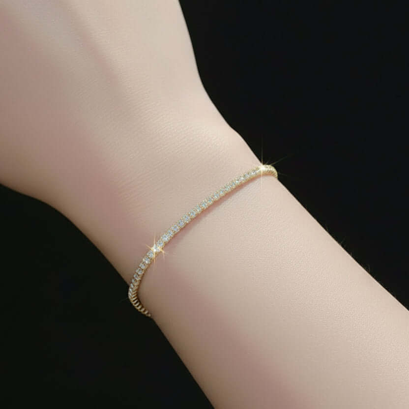 Silver bracelet on a wrist with a lace-trimmed garment in the background