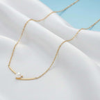 Gold chain necklace with pearl pendant on red fabric, Ceyrah jewelry product photo