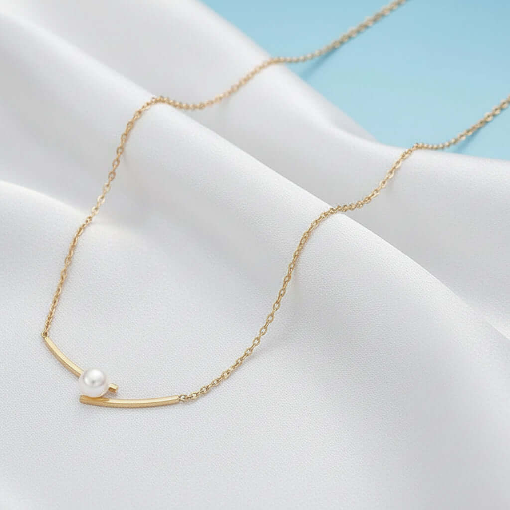 Gold chain necklace with pearl pendant on red fabric, Ceyrah jewelry product photo