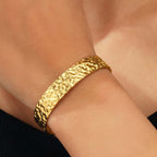 Gold bracelet on a wrist with a close-up view