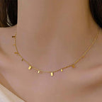 Ceyrah gold geometric pendant necklace on model's neck, minimalist jewelry style