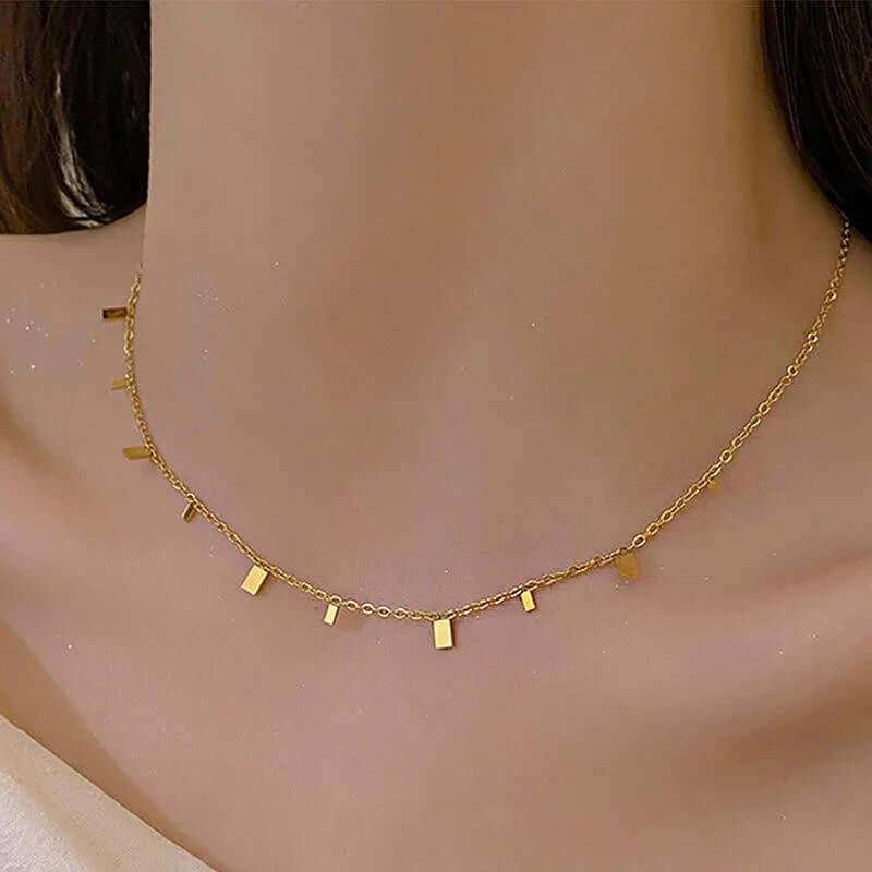 Ceyrah gold geometric pendant necklace on model's neck, minimalist jewelry style