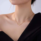 Women wearing Ceyrah gold chain necklace with three small heart charms