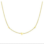 Ceyrah gold chain necklace with three small heart charms on white background