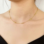 Gold infinity symbol chain necklace on woman's neck, minimalist jewelry by Ceyrah