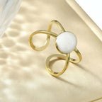 Gold Adjustable Pearl Ring with a pearl on a surface