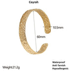 Gold textured bracelet against a white background with measurements
